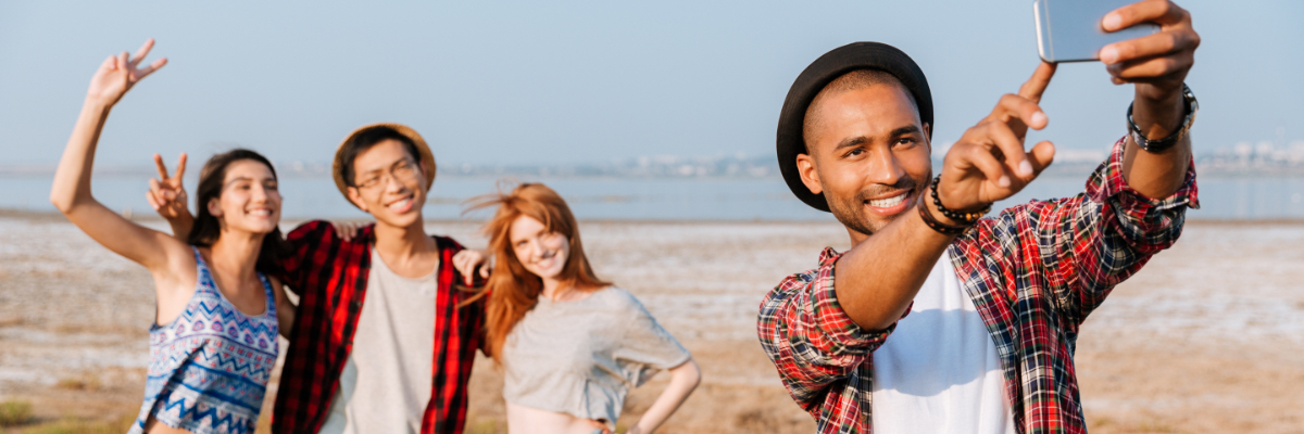 people taking pictures near lake in summer