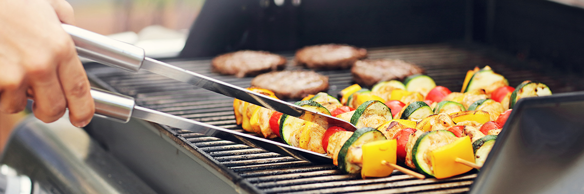 man grilling on shoreline townhome deck