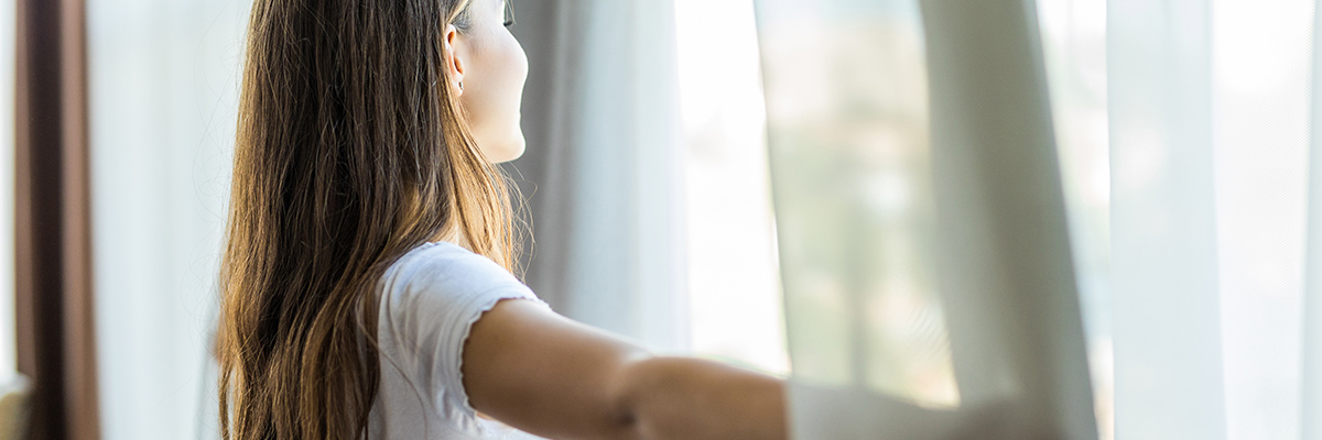 Woman looking out window