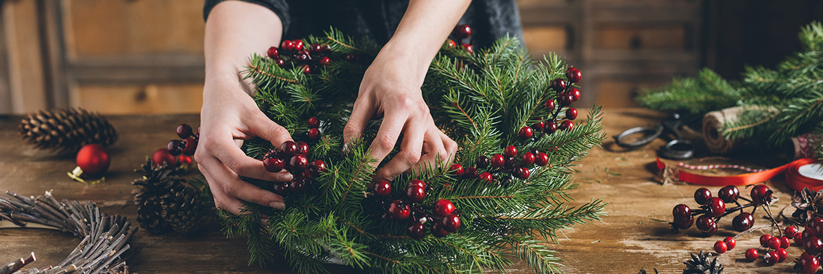 Woman decorating a wreath