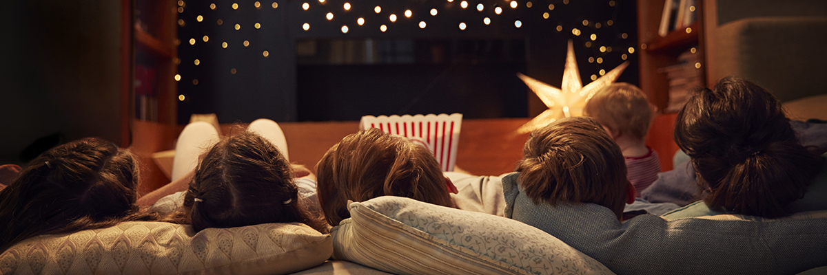 Family on couch enjoying movie night
