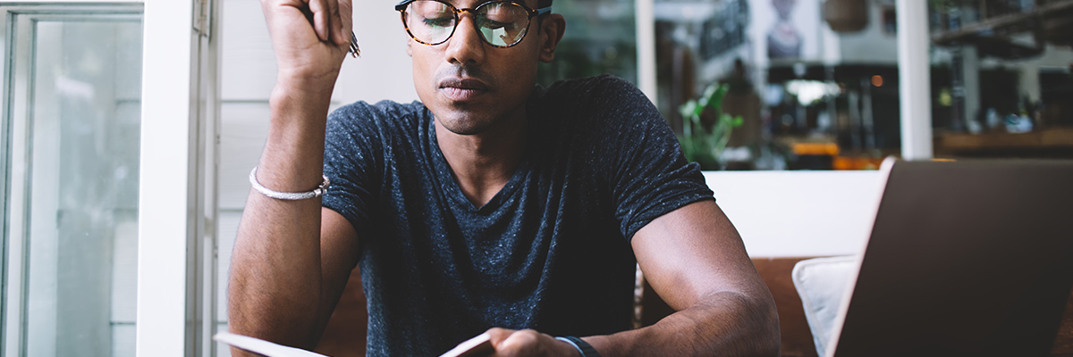 Man looking at notebook